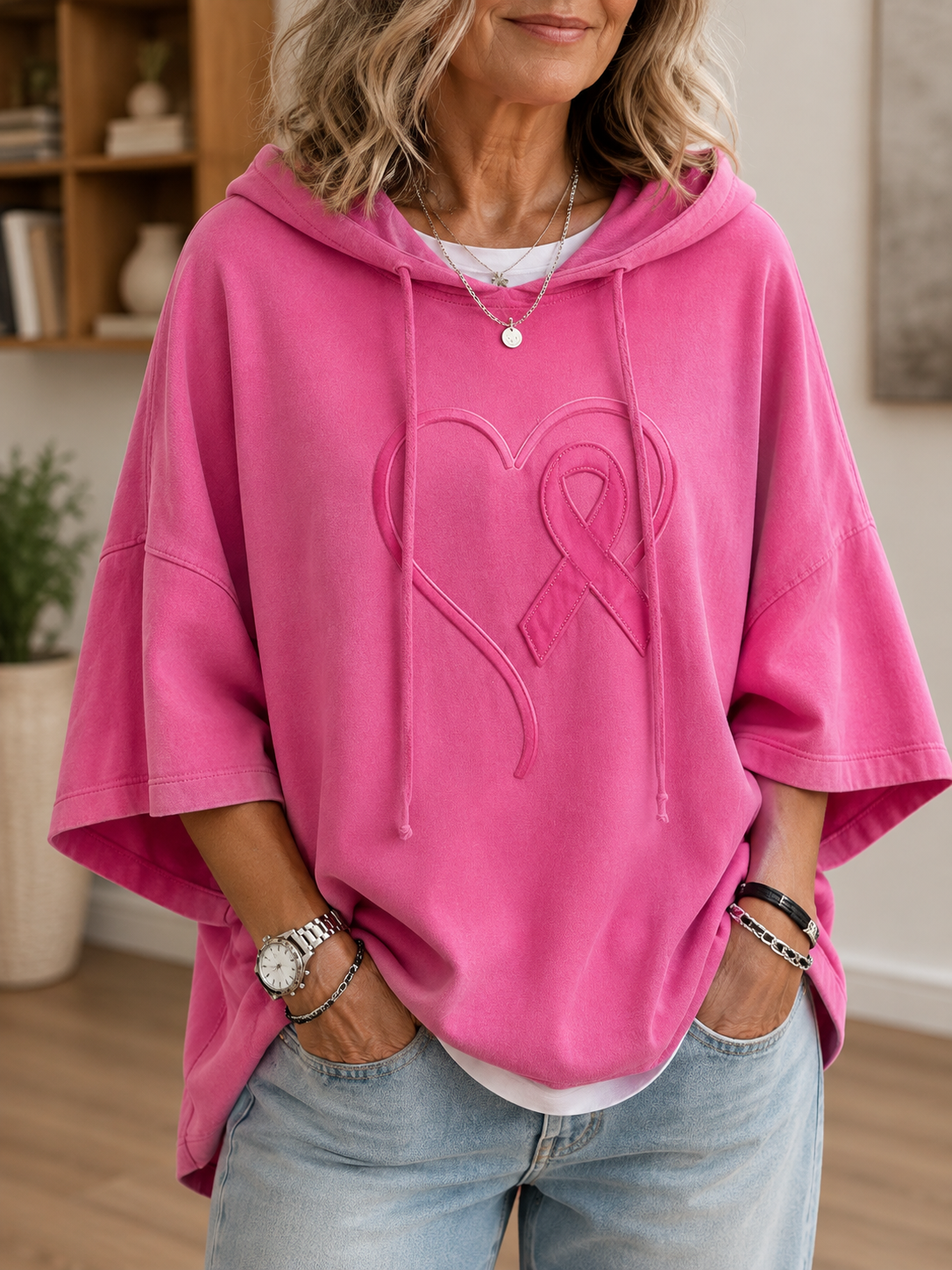 Damehættetrøje med hætte, korte brede ærmer og sløjfemotiv på fronten